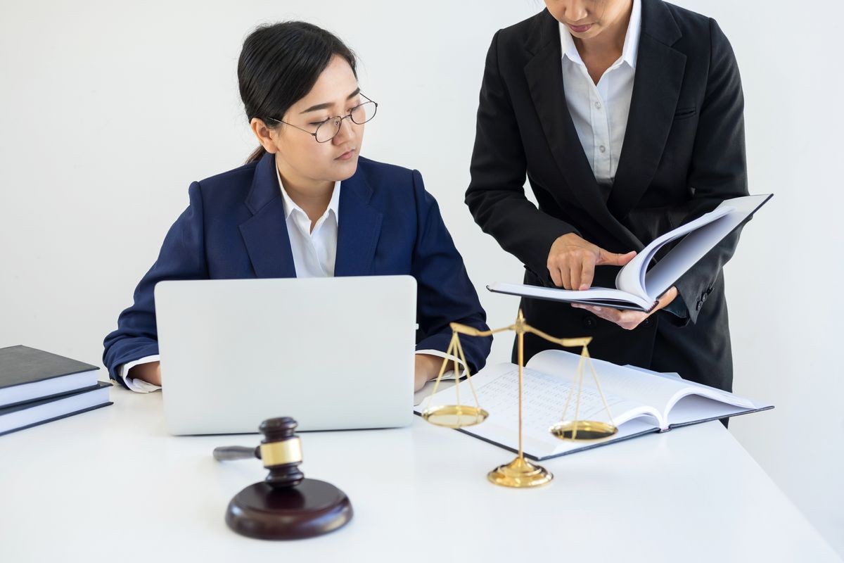 Teamwork of business lawyer colleagues, consultation and conference of professional female lawyers working having at law firm in office. Concepts of law, Judge gavel with scales of justice.