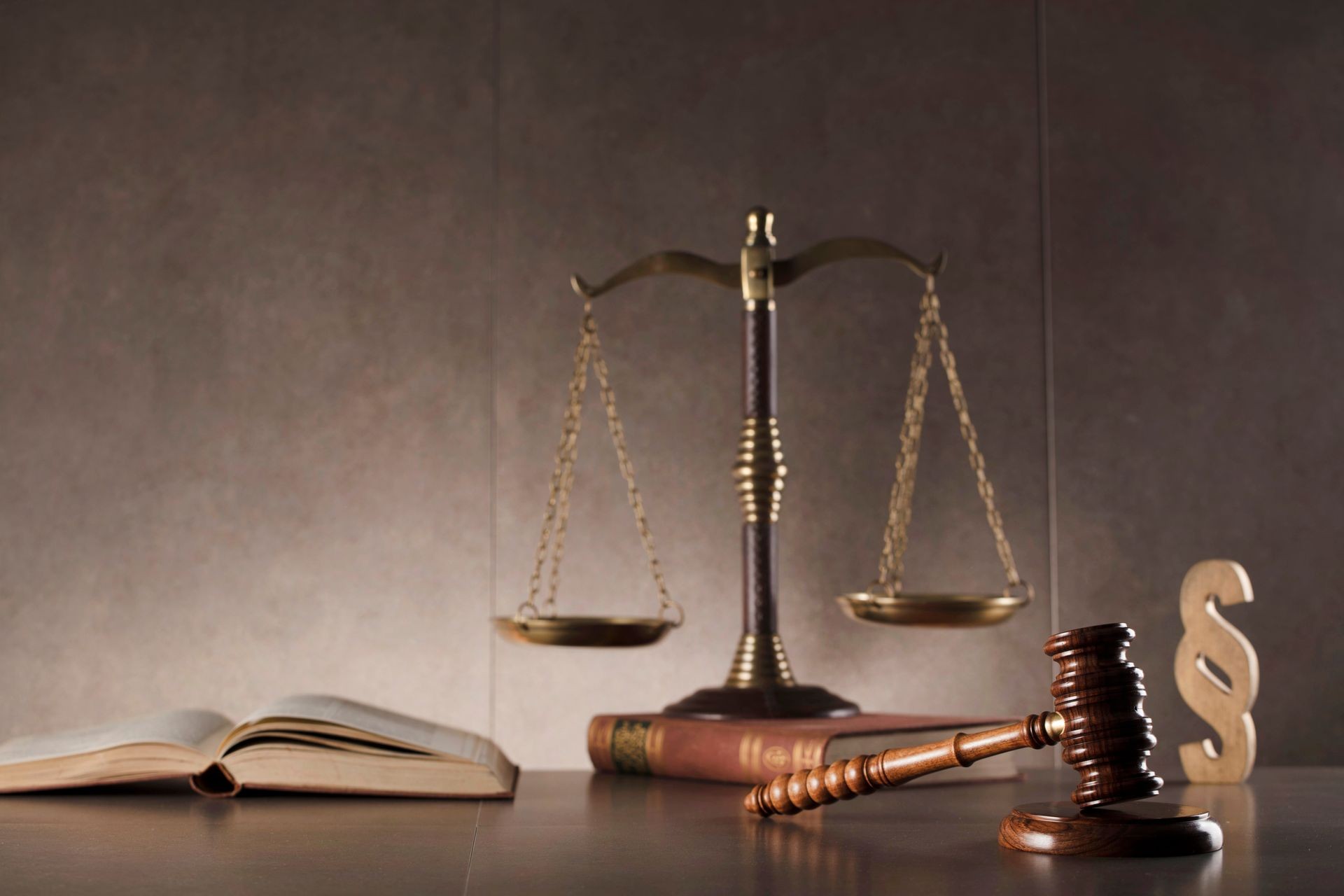 Law and justice concept background. Gavel, scales of justice, books. Gray stone background, place for typography.